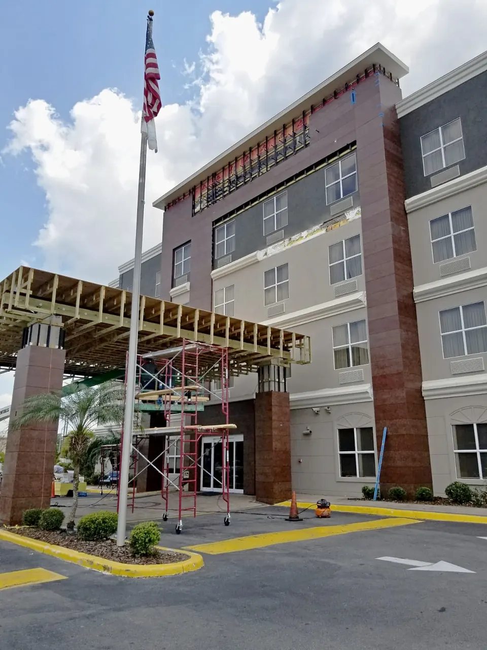 New porte-cochère canopy framing over the entry columns, front view